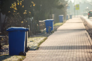 Garbage Cans In Line On The Side Of The Road. Environmental Protection Concept